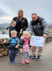 Dorothy Ralston, Fergus Walker and their children Maida, William and Eilidh with their supportive sign reading: 'Well done, girls!'