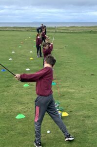 The youngsters perfecting their swings.